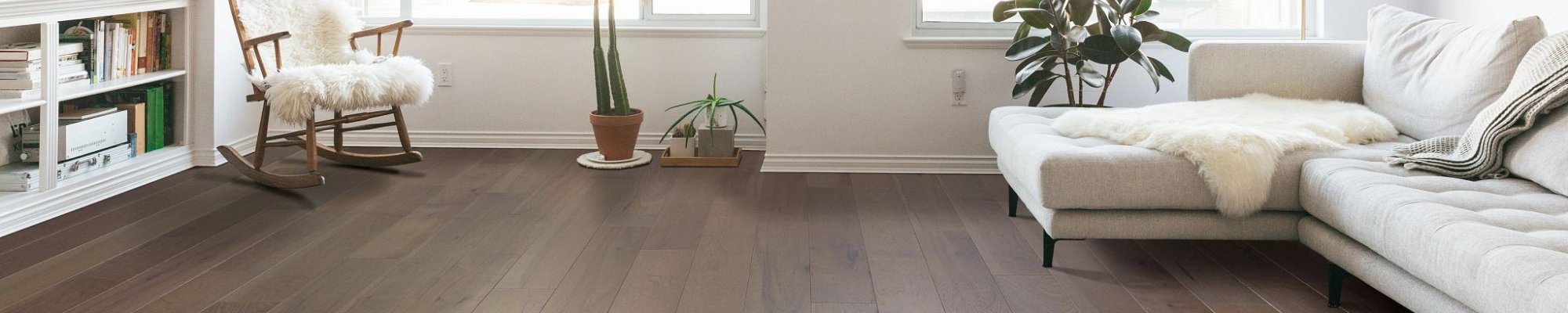 Couch and chair on hardwood - Cornerstone Flooring Brokers Sun City in Sun City, AZ